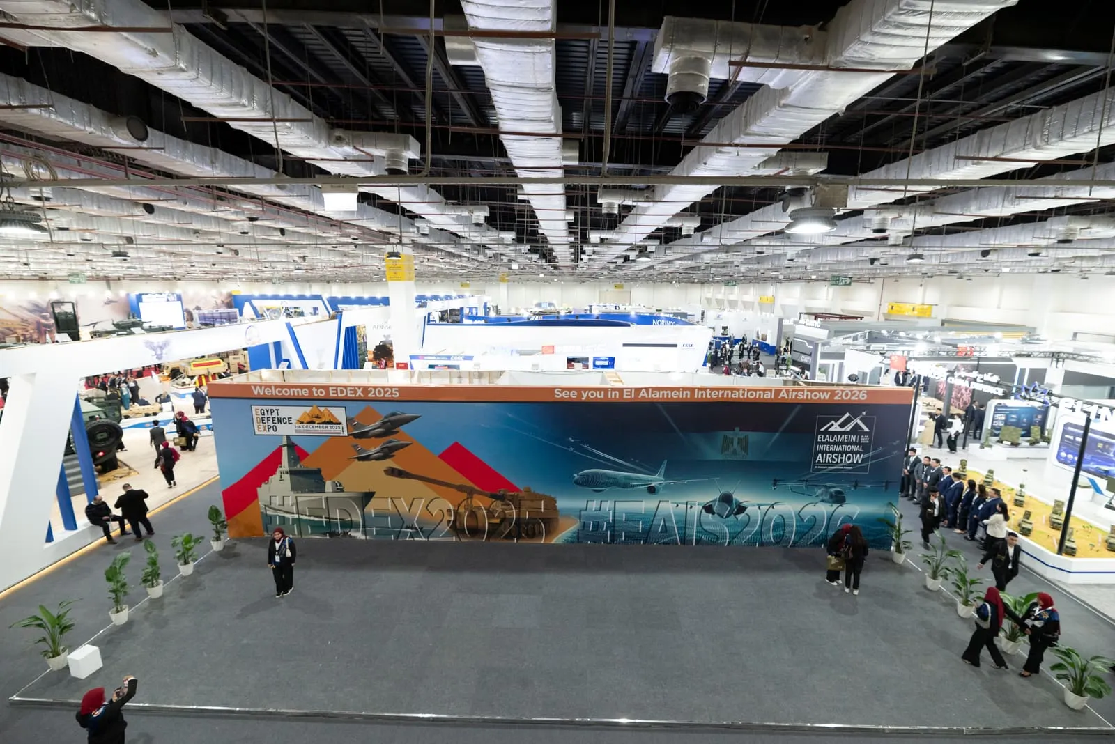 Elevated view over a busy international exhibition hall