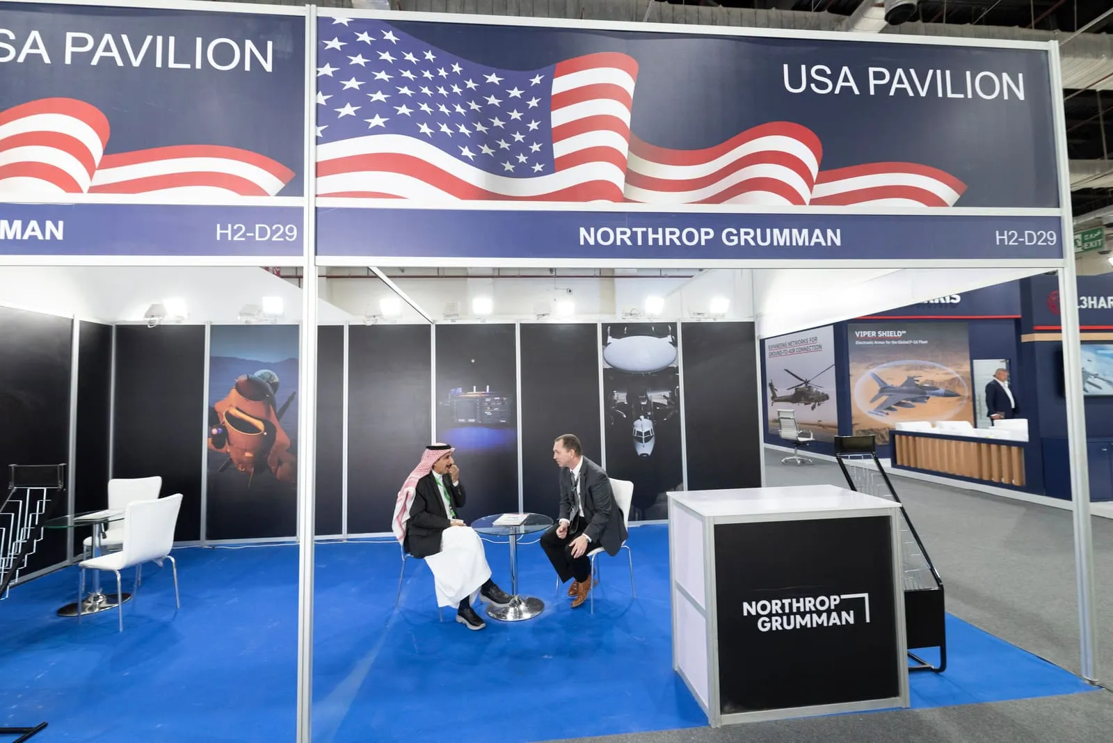 USA national pavilion at a defence exhibition with a meeting in progress